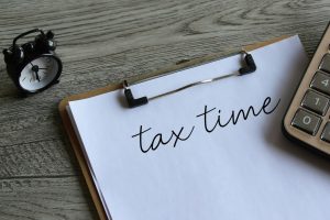Alarm clock and calculator with text TAX TIME.